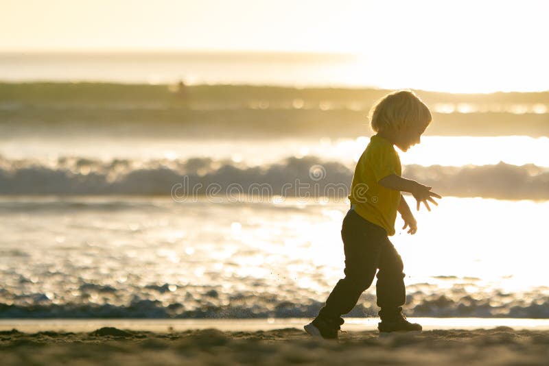 Blond Little Boy Walking on the Beach by the Ocean Stock Image - Image ...