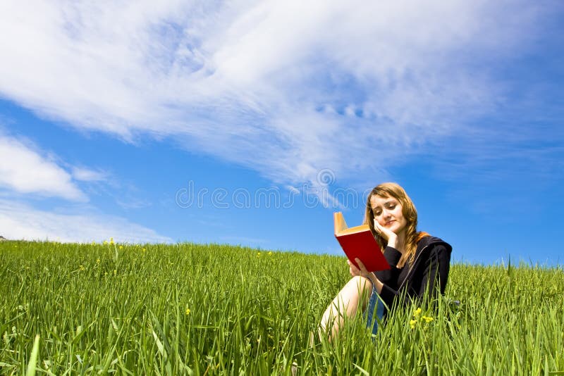 Blond reading on grass