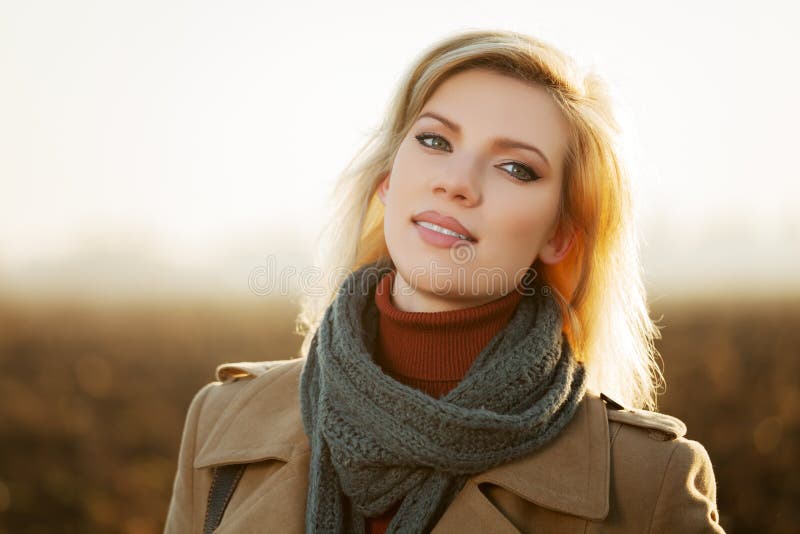 Happy blond fashion woman in autumn field