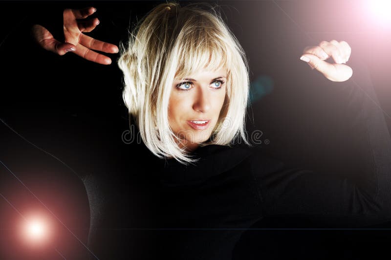 Blond woman dancing in the dark stock images