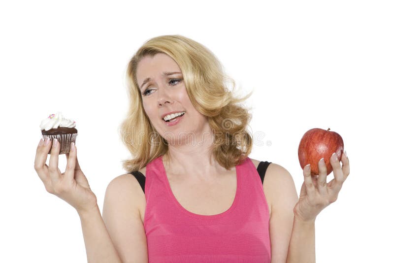 Blond woman decides between a cupcake and an apple