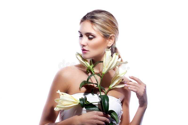 Blond woman with fresh clean skin and white lily flower isolated stock photos Blond woman with fresh clean skin and white lily flower isolated stock photos