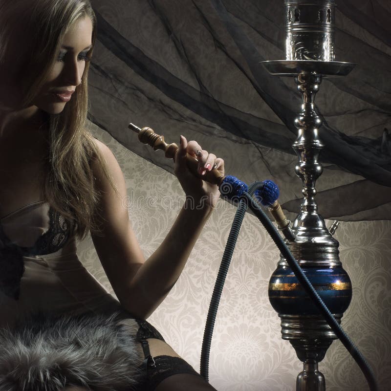 A Blond Woman In Lingerie Smoking A Hookah Stock