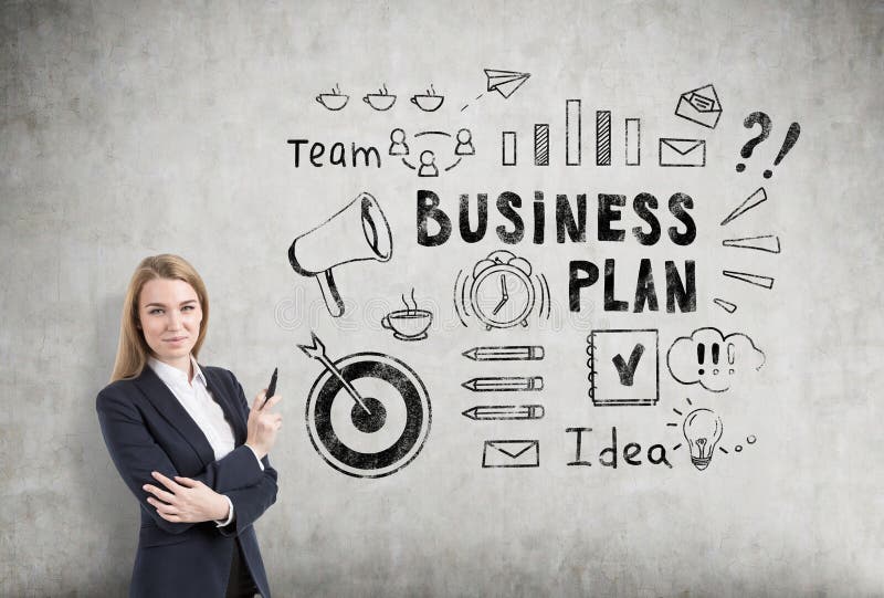 Blond woman with a marker near a business plan sketch on a concrete wall stock image Blond woman with a marker near a business plan sketch on a concrete wall stock image