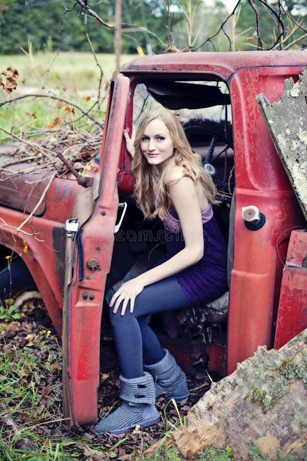 Blond woman in old truck