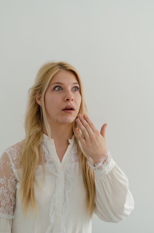 Blond woman with surprised look on her face stock photo Blond woman with surprised look on her face stock photo