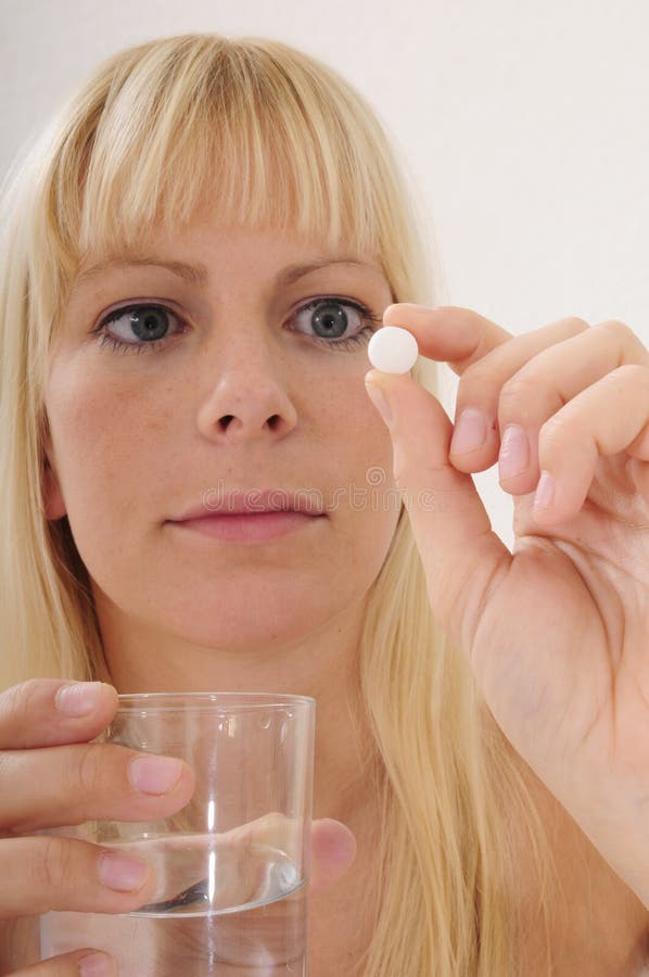Blond woman taking a pill