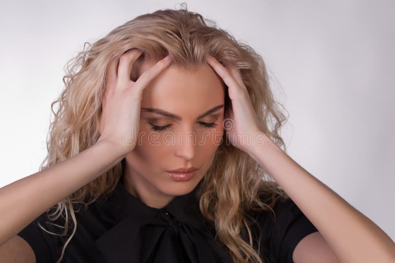 Blond young woman with a headache