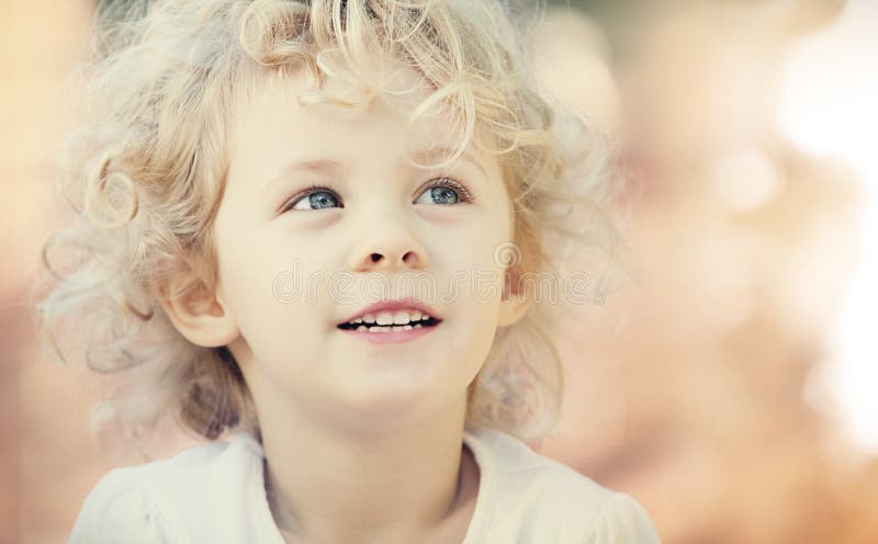 Blonde baby girl smiling outdoor