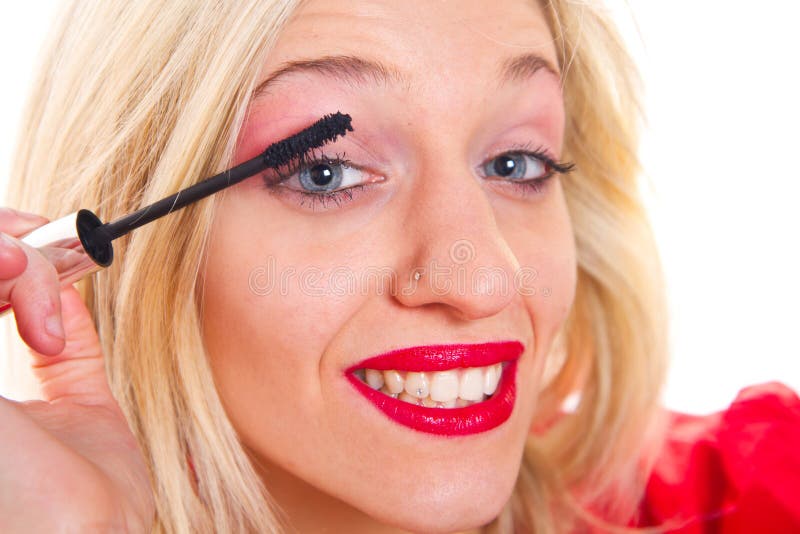 Blonde Beauty that Puts Mascara Stock Photo Image of model