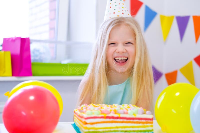 Blonde Caucasian Girl Laughing at Camera Near Birthday Rainbow Cake ...