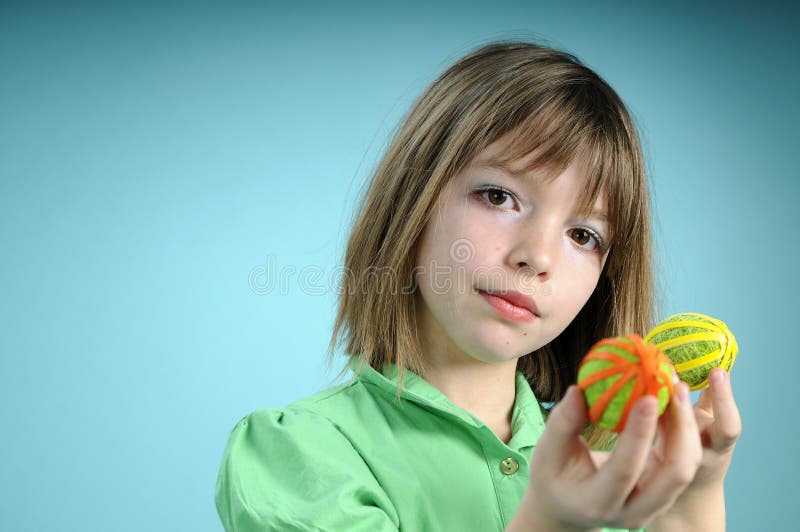 Blonde child showing easter ornaments