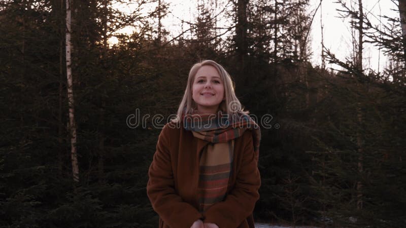 Blonde in the forest during sunset