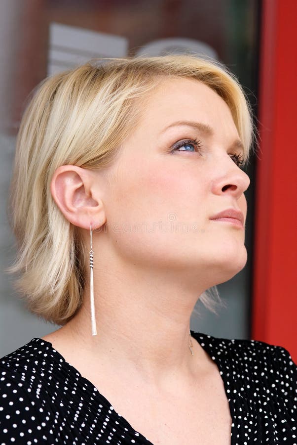 Blond woman looking up with peaceful expression. Blond woman looking up with peaceful expression.