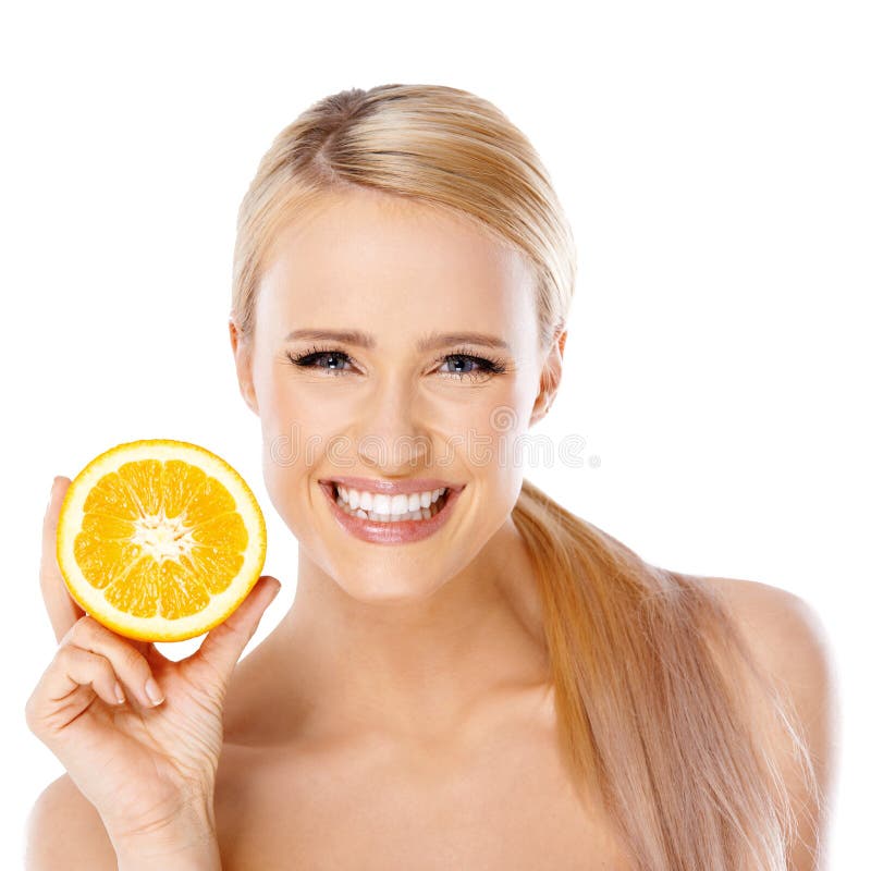 Blond woman with beautiful smile holding fresh half of orange. Blond woman with beautiful smile holding fresh half of orange