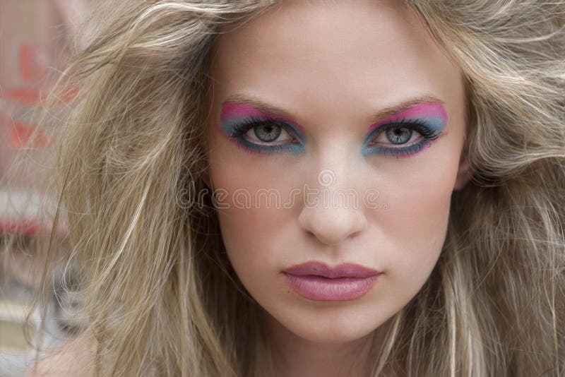 Blond woman with dramatic pink and blue eye makeup. Blond woman with dramatic pink and blue eye makeup