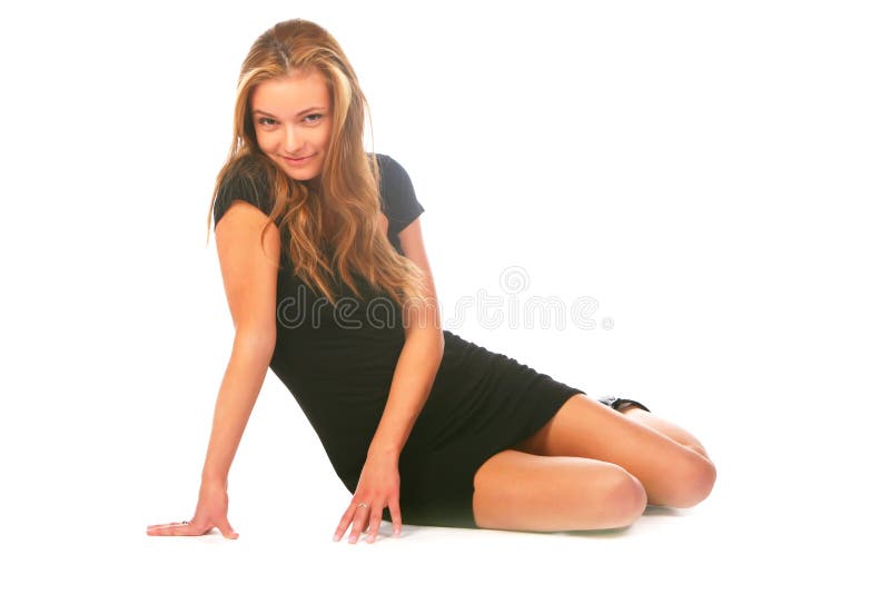 Blonde girl in the black dress, sitting on a white