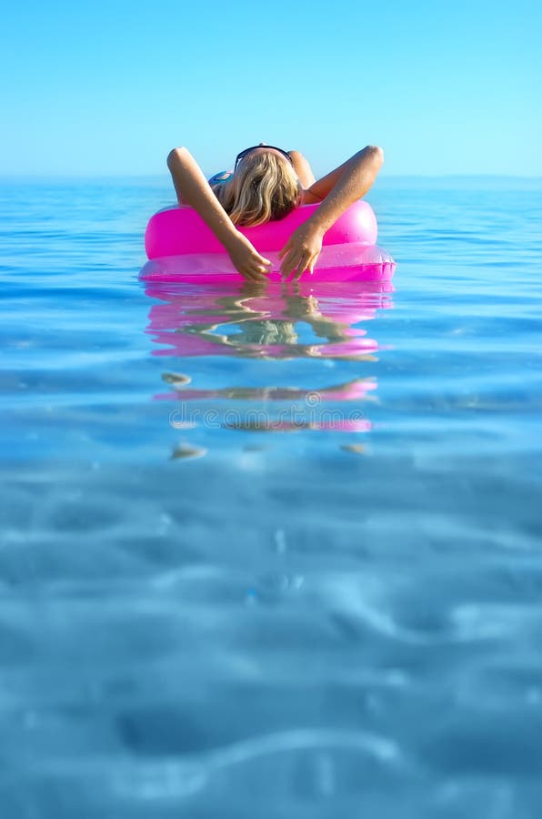 Blonde girl on inflatable raft