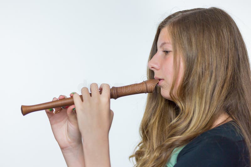 Blonde girl playing flute royalty free stock photography