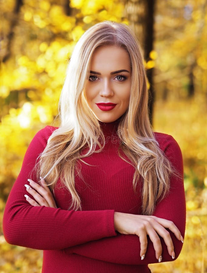 Blonde Girl Portrait At The Autumn Forest Back View At Falling Leaves