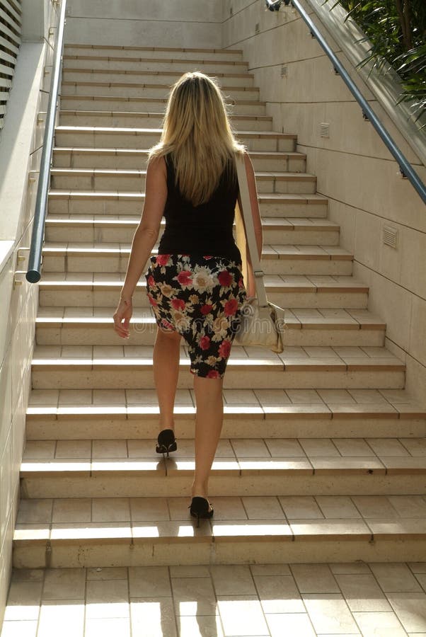 Beautiful Woman Walking Down The Stairs Stock Photo 