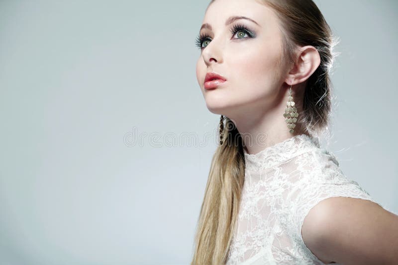 Blonde girl on white background close-up.