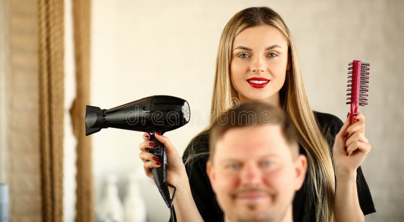 Blonde Hairstylist Using Dryer and Comb for Man stock photography Blonde Hairstylist Using Dryer and Comb for Man stock photography
