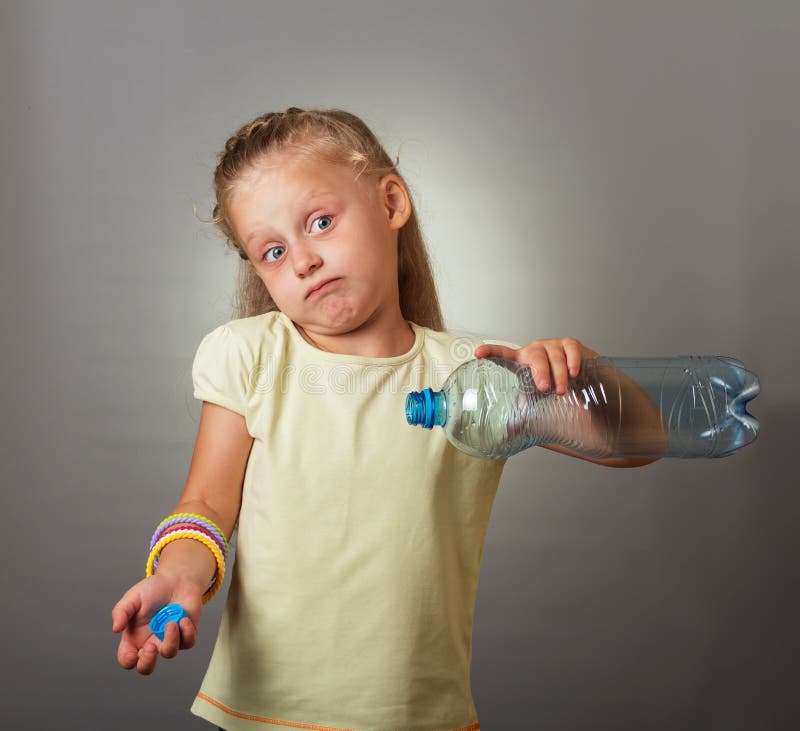 Blonde little girl surprised by an empty water bottle