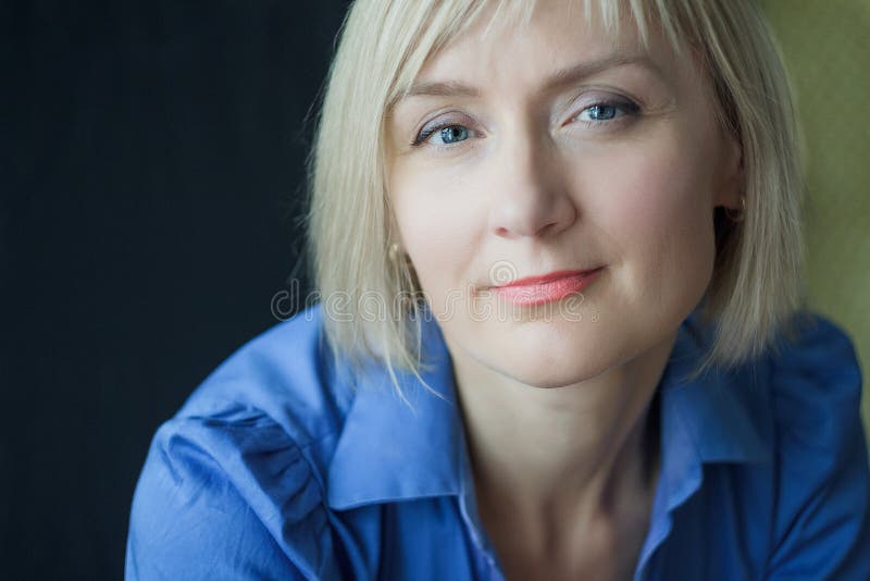 Blonde mature woman close-up studio portrait