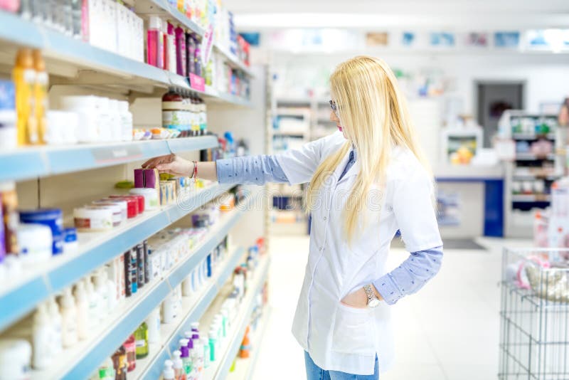 Blonde pharmacist selling antibiotics and prescription drugs. Pharmaceutical medical details