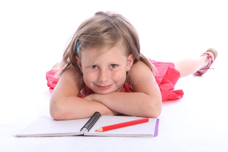 Blonde primary school girl with pencil and paper