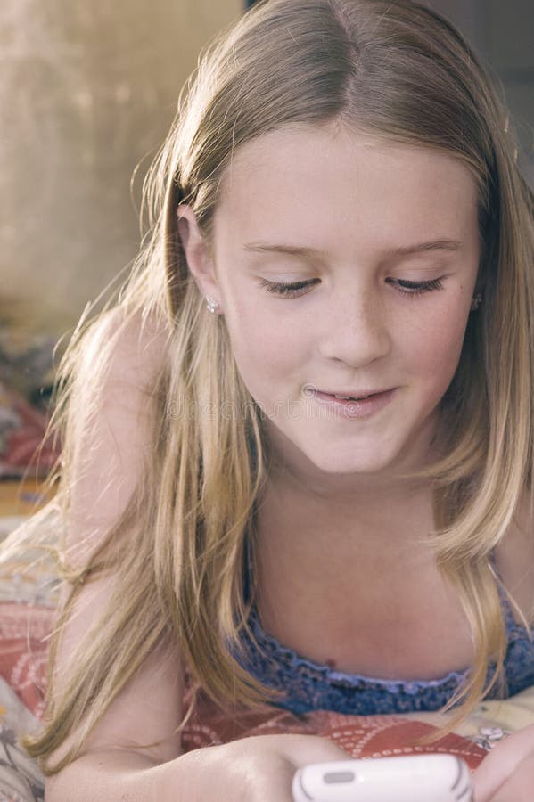 Blonde Teen Girl Texting on Her Phone Stock Photo amateur hq picture Blonde Teen Girl Texting on Her Phone Stock Photo photo image
