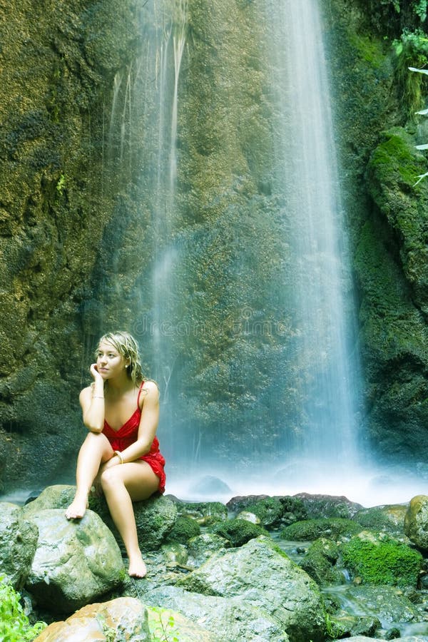 Blonde under waterfall