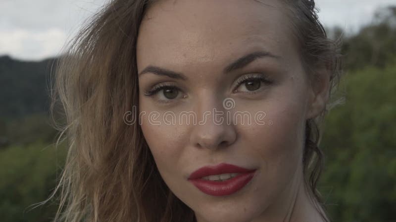 Blonde woman closeup portrait smiling outdoors