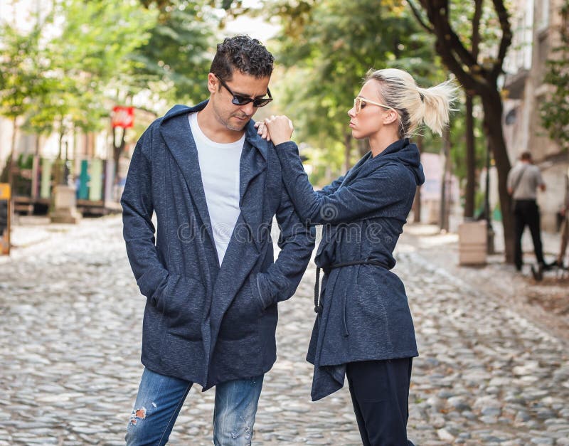 Blonde woman and handsome man posing on the street royalty free stock image Blonde woman and handsome man posing on the street royalty free stock image