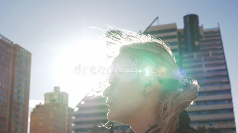 Blonde woman walking on the street in slowmo