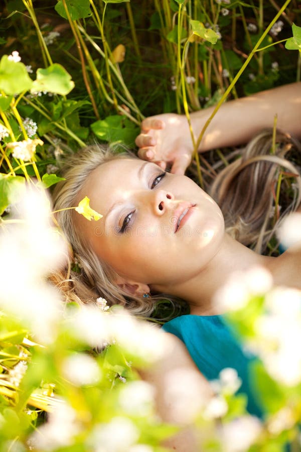 Blonde woman wearing blue dress on a field