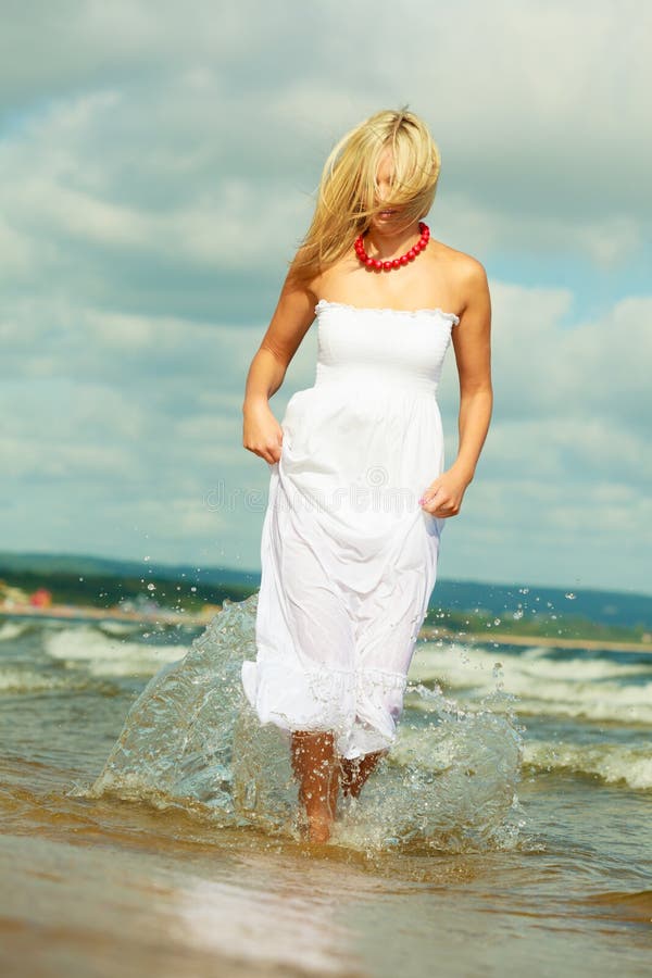 Blonde Woman Wearing Dress Walking In Water Stock Image Image Of 