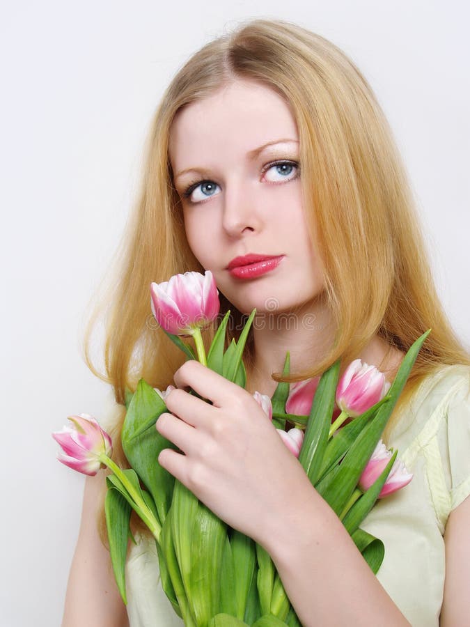 Blonde young women with pink tulips