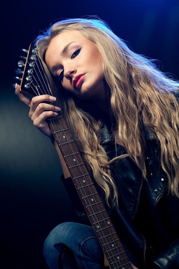 Blond woman rock star portrait with guitar. Blond woman rock star portrait with guitar