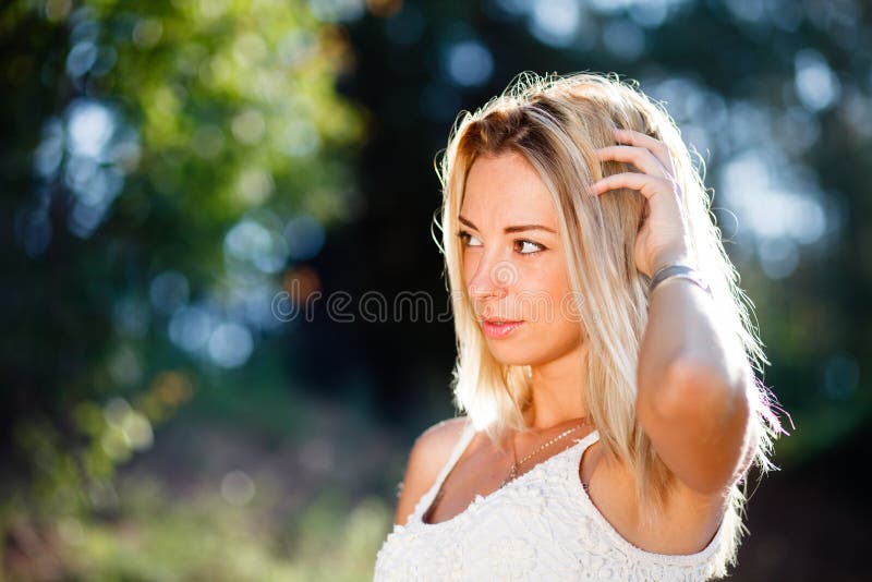 A Blond young girls summer outdoor portrait. A Blond young girls summer outdoor portrait