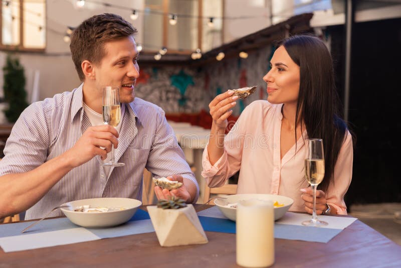 Blonde-haired man. Blonde-haired elegant men inviting her appealing women for drinking champagne and eating oysters. Blonde-haired man. Blonde-haired elegant men inviting her appealing women for drinking champagne and eating oysters