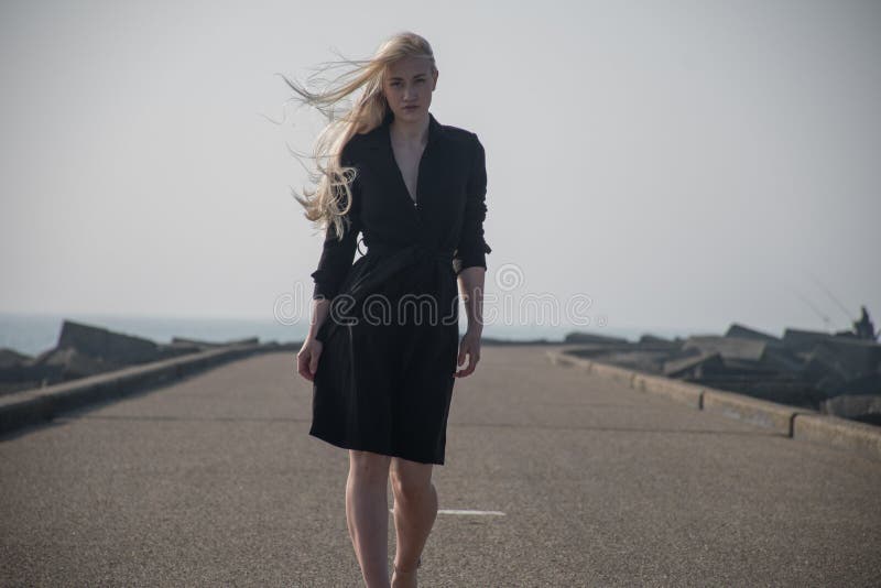 blondynki dziewczyna w czarnym żakiecie przy molem zdjęcie stock blondynki dziewczyna w czarnym żakiecie przy molem zdjęcie stock