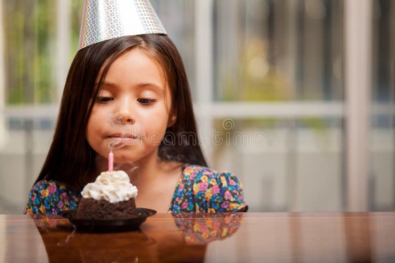 Blowing a candle on her birthday royalty free stock photo Blowing a candle on her birthday royalty free stock photo