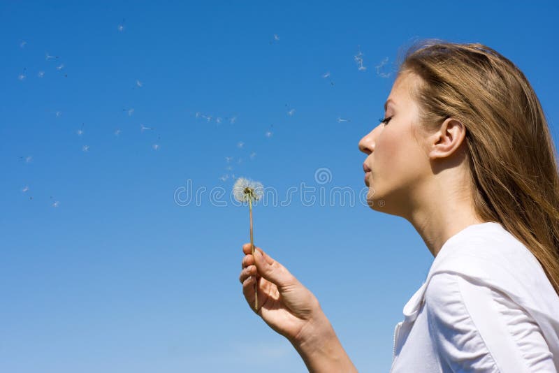 Blowing on dandelion