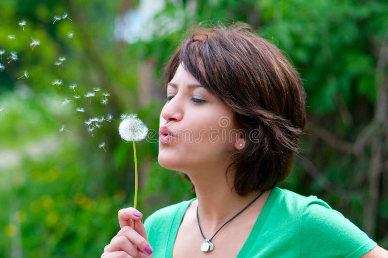 Blowing a dandelion