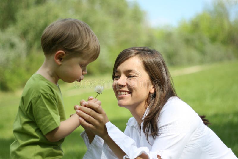 Mother and son having fun with dandelion - leisure activity. Mother and son having fun with dandelion - leisure activity