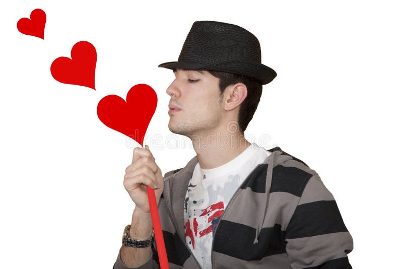 Young boy blowing on a white background isolated hearts. Young boy blowing on a white background isolated hearts