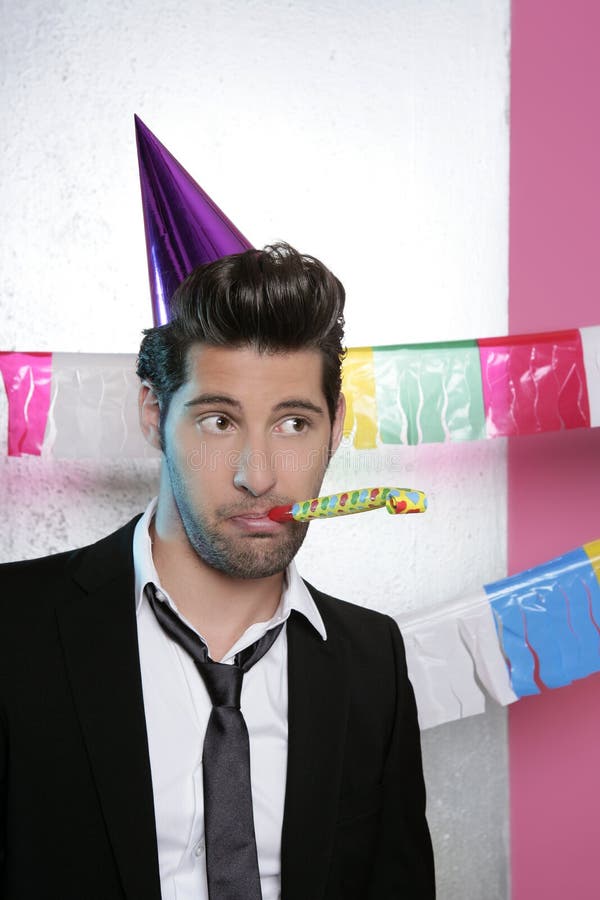 blowing noisemaker suit party funny young man 16225530