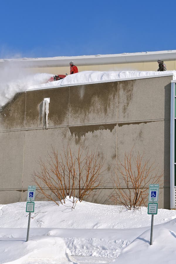 Blowing snow off a roof stock photo. Image of threat - 141897574